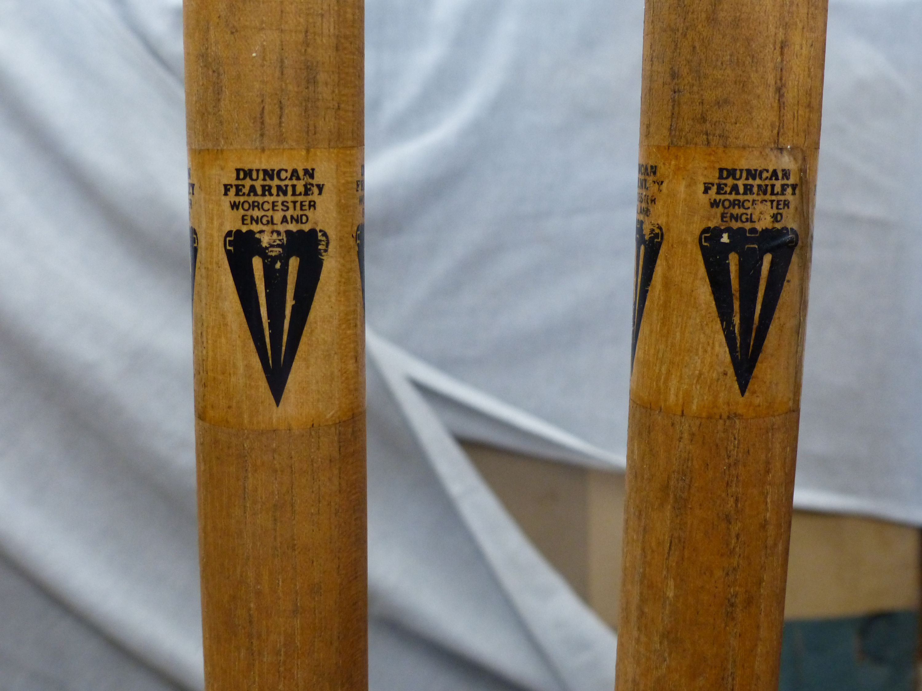 A vintage sled, a set of practise cricket stumps on sprung cast iron base